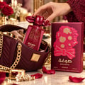 Asdaaf Sougha — Red perfume bottle with gold speckles and ornate floral embossed box with a red bow