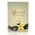 Al Rehab Spanish Vanilla Eau De Parfum 100ml — A clear glass perfume bottle with golden liquid and a black cap sits in front of its cream-colored box, which features a yellow orchid and vanilla bean illustration. | Al Rehab Spanish Vanilla Eau De Parfum 100ml — Botol minyak wangi kaca jernih dengan cecair keemasan dan