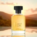 Al Rehab Spanish Vanilla Eau De Parfum 100ml — A clear glass perfume bottle with golden liquid and a black cap sits in front of its cream-colored box, which features a yellow orchid and vanilla bean illustration. | Al Rehab Spanish Vanilla Eau De Parfum 100ml — Botol minyak wangi kaca jernih dengan cecair keemasan dan