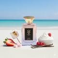 Bujairami Sugar Rush Eau de Parfum — Glass bottle with gold cap and gradient pink-blue liquid next to matching box.