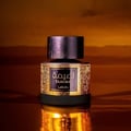 Lattafa Tamima — Black perfume bottle with gold label and black cap, next to a black product box with gold Arabic script and text | Lattafa Tamima — Botol minyak wangi hitam dengan label emas dan penutup hitam, bersebelahan kotak produk hitam dengan skrip Arab emas dan teks