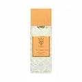 Bujairami Too Damn Good — Clear faceted glass perfume bottle with wooden cap next to orange leather box with gold logo