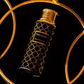 Maison Asrar Treasure by Maison Asrar 100ml EDP Unisex — Black bottle with gold geometric pattern and gold ornate cap, featuring a gold label with 'TREASURE ROYAL COLLECTION' text.