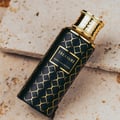 Maison Asrar Treasure by Maison Asrar 100ml EDP Unisex — Black bottle with gold geometric pattern and gold ornate cap, featuring a gold label with 'TREASURE ROYAL COLLECTION' text.