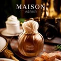Maison Asrar Vanilla Voyage — Amber glass perfume bottle with a textured peach cap and gold trim, next to its peach box with a perfume silhouette.