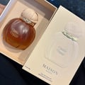 Maison Asrar Vanilla Voyage — Amber glass perfume bottle with a textured peach cap and gold trim, next to its peach box with a perfume silhouette.