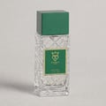 Bujairami Vibration by Bujairami 100ml Extrait de Parfum — Clear glass bottle with green cap and label next to a green
