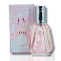 Ard Al Zaafaran Yara Eau De Parfum 50ml — Pink floral patterned box next to a faceted pale pink perfume bottle with a silver cap. | Ard Al Zaafaran Yara Eau De Parfum 50ml — Kotak bercorak bunga merah jambu di sebelah botol minyak wangi merah jambu pucat berfaset dengan penutup perak.