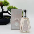 Ard Al Zaafaran Yara Eau De Parfum 50ml — Pink floral patterned box next to a faceted pale pink perfume bottle with a silver cap. | Ard Al Zaafaran Yara Eau De Parfum 50ml — Kotak bercorak bunga merah jambu di sebelah botol minyak wangi merah jambu pucat berfaset dengan penutup perak.
