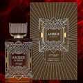 Zimaya Amber Is Great Eau De Parfum 100ml — A brown textured box with gold geometric art deco design stands next to a rectangular glass perfume bottle with a ribbed brown cap and gold geometric art deco design. The bottle contains amber-colored liquid. | Zimaya Amber Is Great Eau De Parfum 100ml — Kotak bertekstur