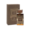 Zimaya Amber Is Great Eau De Parfum 100ml — A brown textured box with gold geometric art deco design stands next to a rectangular glass perfume bottle with a ribbed brown cap and gold geometric art deco design. The bottle contains amber-colored liquid. | Zimaya Amber Is Great Eau De Parfum 100ml — Kotak bertekstur